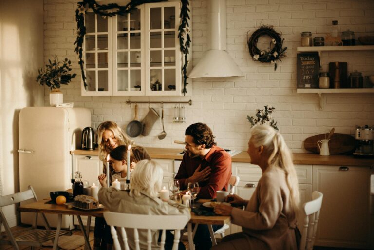 family sits on table inside kitchen