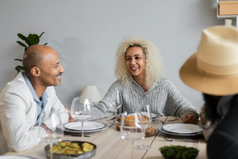 smiling people at table with food