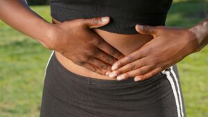 close up photo of woman touching her abdomen